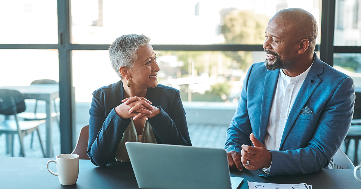 Manager and employee having conversation click to explore the article