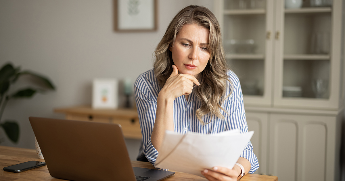 Woman looking at papers. Click to explore the article