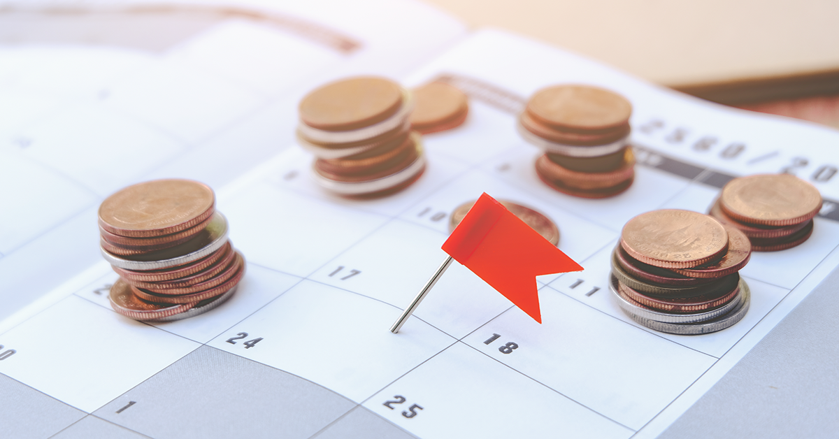 Stacks of coins on top of a calendar
