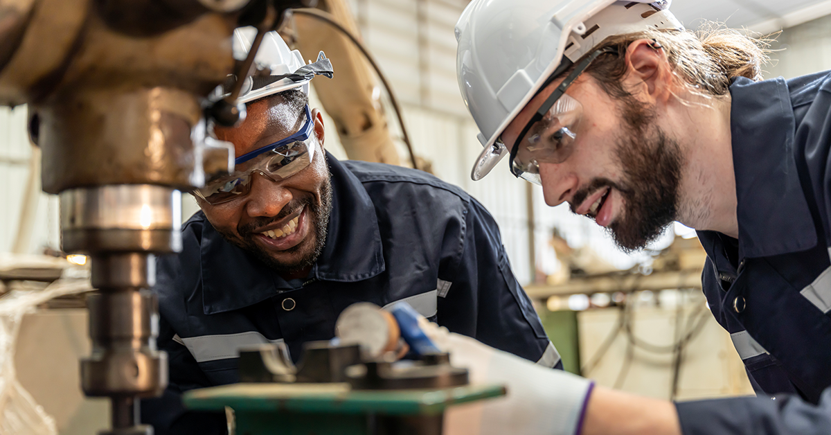 Engineers taking care and practicing maintenance of old machines in a factory