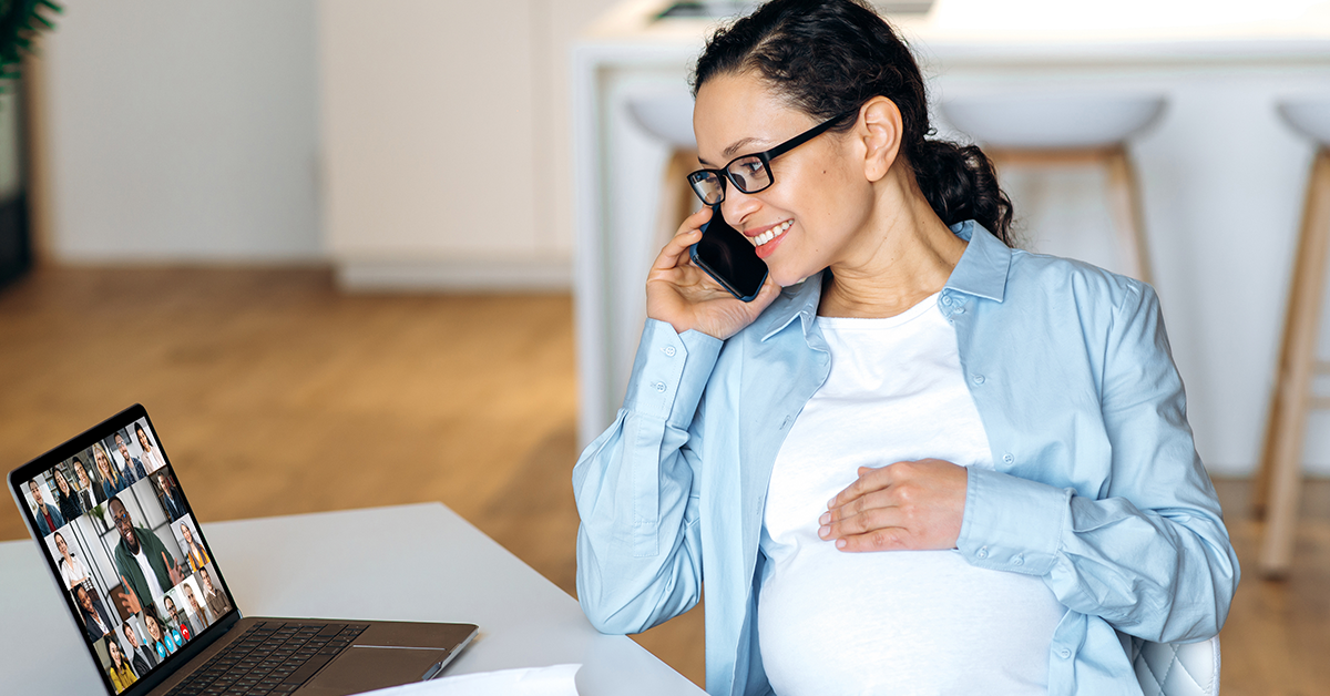 Pregnant woman taking a work meeting at home