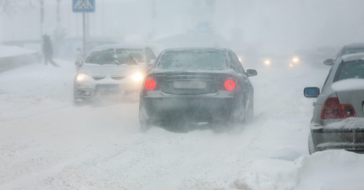 Cars driving in winter traffic, low visibility