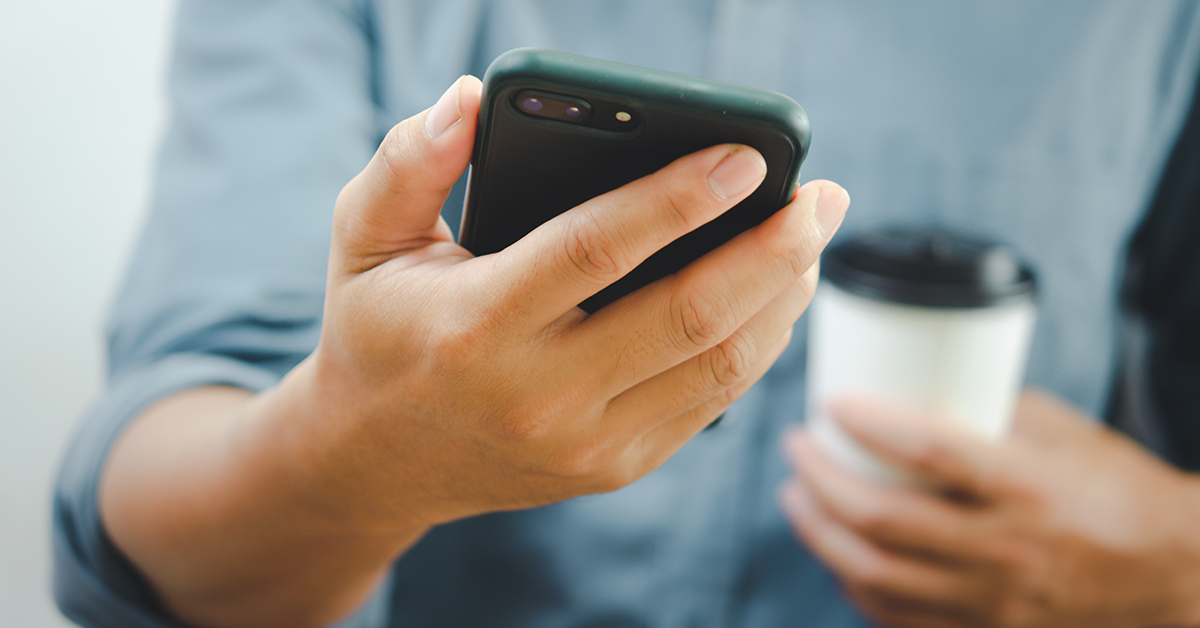 Man holding cell phone. Click to explore the article