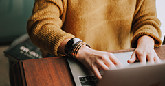 Hands of woman working on a laptop