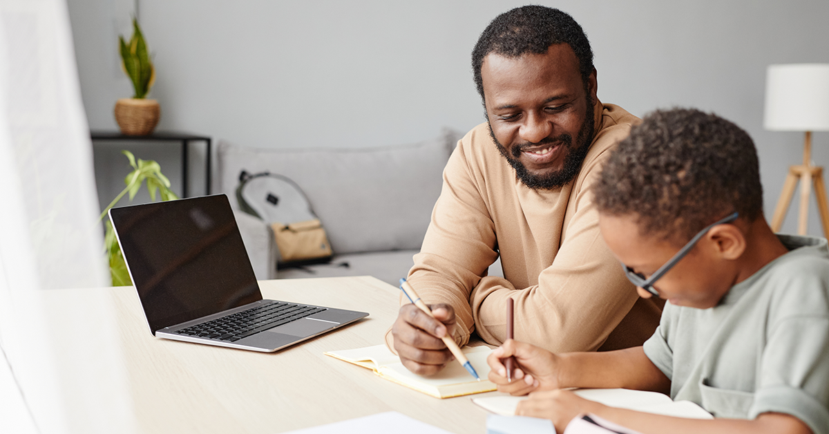 African American Boy Studying with Father at Home