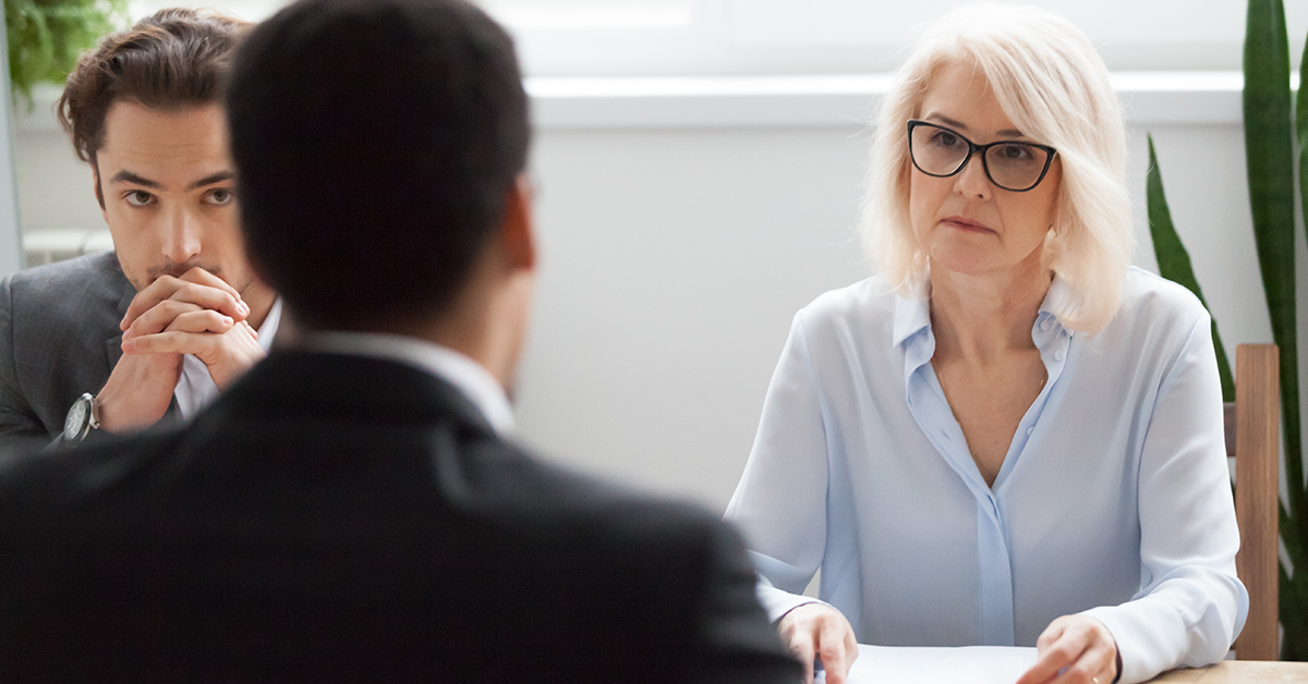 Serious, attentive female senior candidate at job interview 