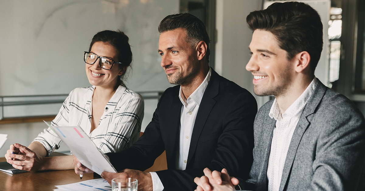 Group of business people sitting at table in office during job interview