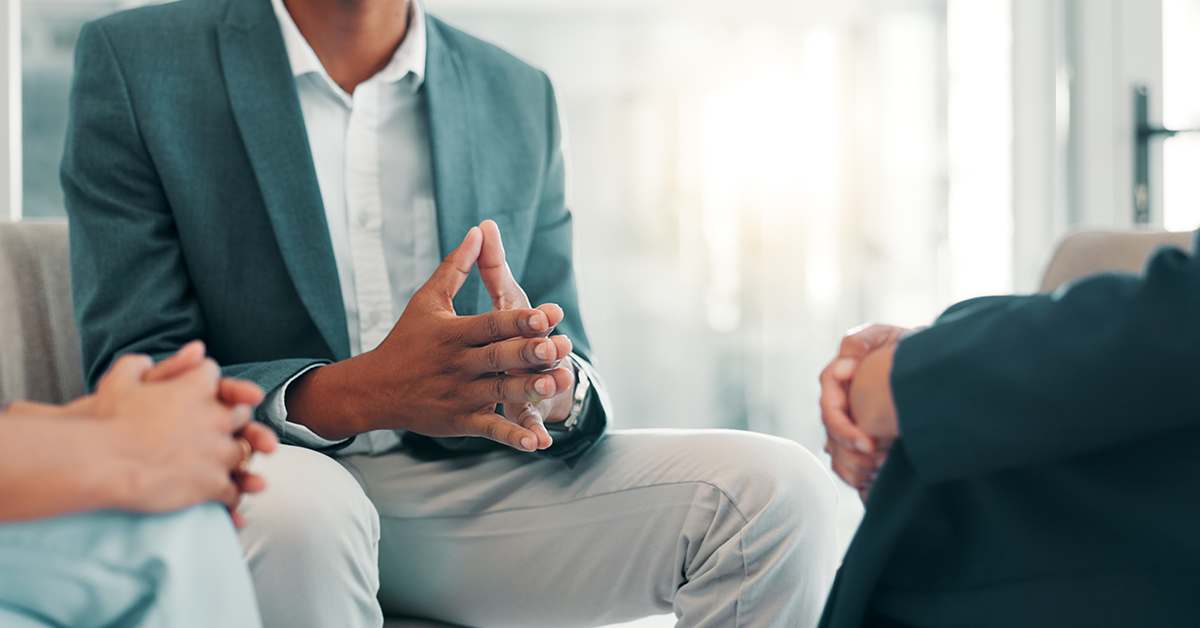 Meeting in a group, business people sitting with folded hands 