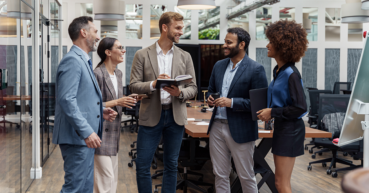 Group of business people talking in office during break