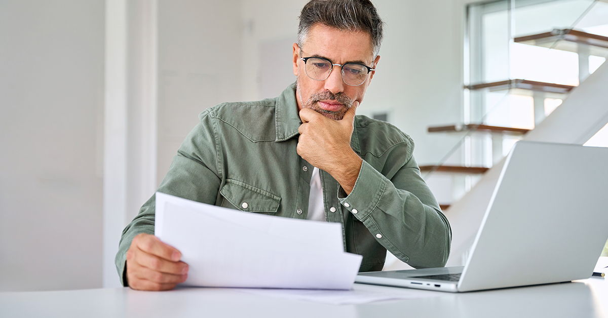 Serious businessman, looking at document intently