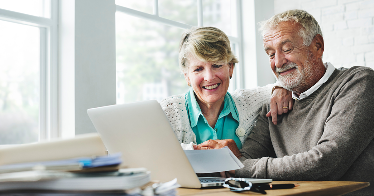 Senior couple reviewing document together at home