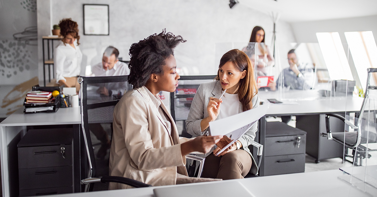 Women coworkers brainstorming in office setting