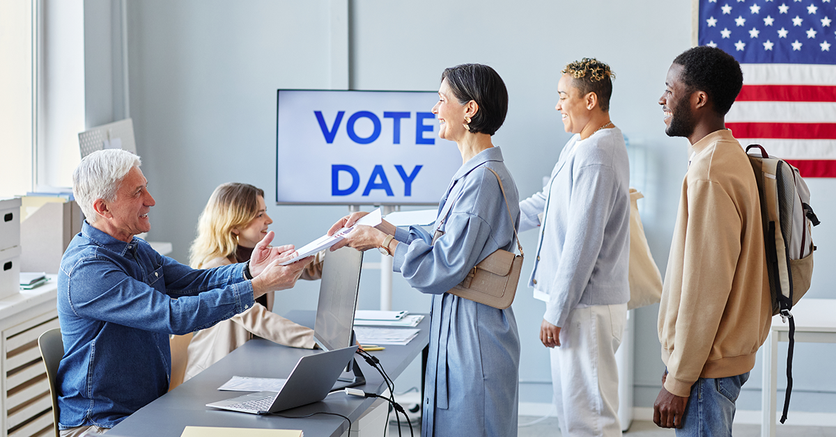 Diverse group of people in line at voting station on election day