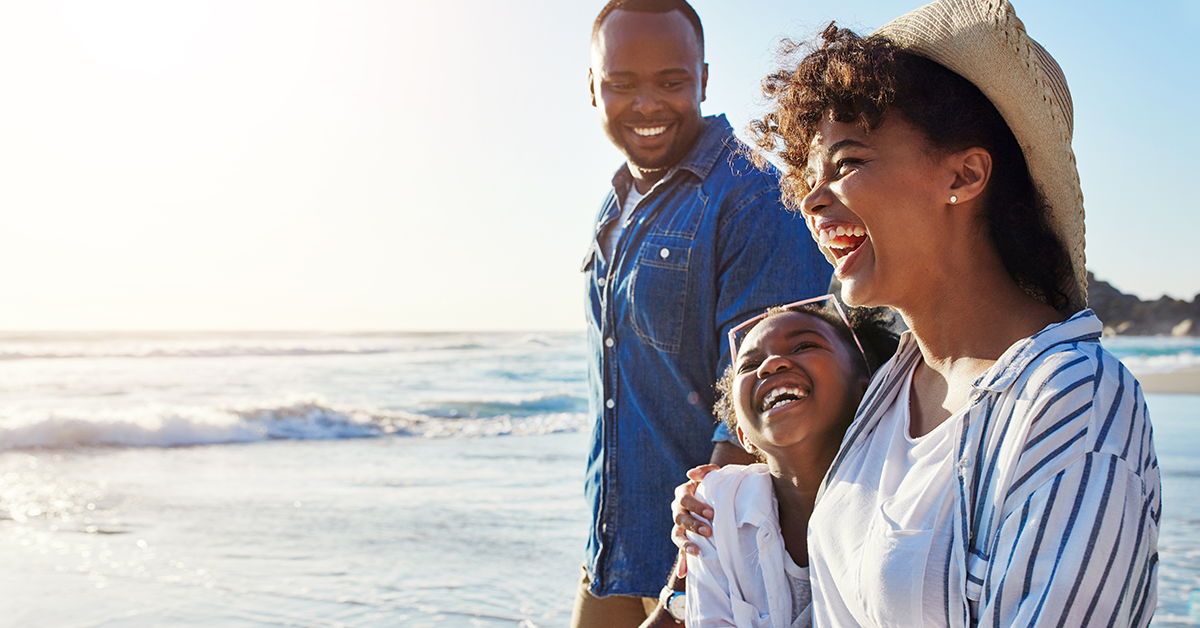 Family walking on a beach with child on vacation