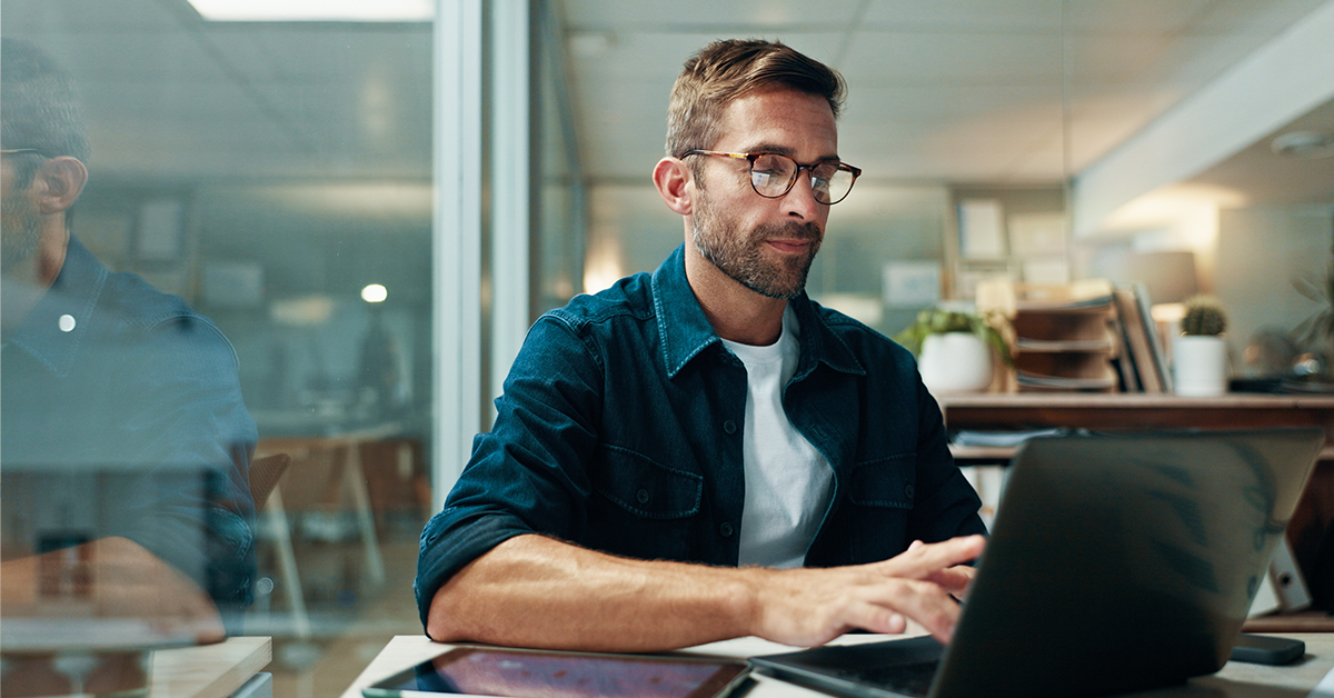 Businessman typing on laptop in office