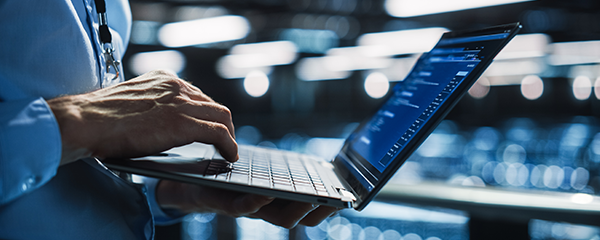 Person using laptop computer to review data and information