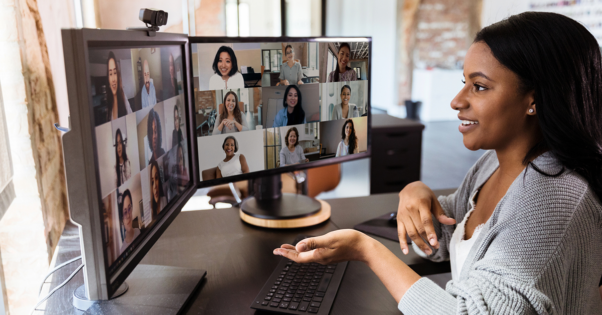 Woman gestures during virtual meeting with colleagues