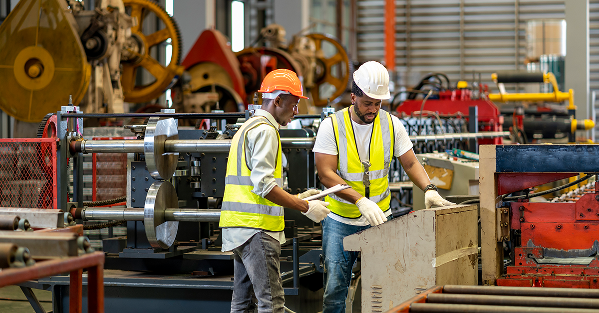 Industrial workers in a factory with hard hats